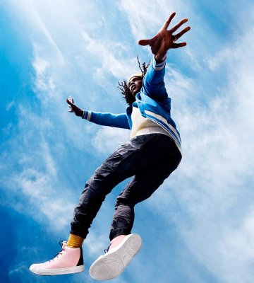 Guy jumping in the air with yy nation shoes on