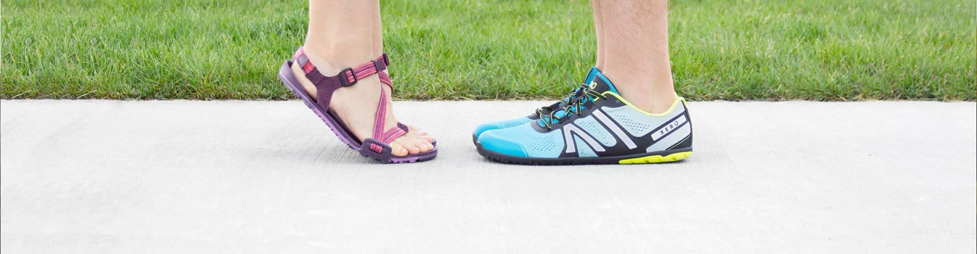2 people standing on sidewalk with Xero shoes on 